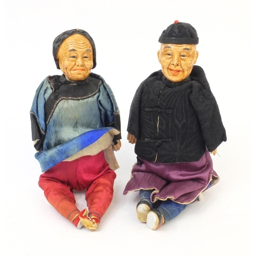 560 - Two Oriental dolls with composite heads and limbs, tallest 26cm high