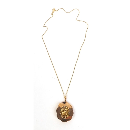 857 - Unmarked gold floral pendant on a 14ct gold necklace, the pendant 4cm long, approximate weight 5.4g