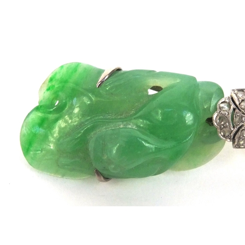 517 - Chinese carved green jade brooch set with diamonds, the jade carved with a dragon, 6.5cm long, appro... 