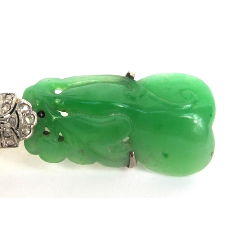 517 - Chinese carved green jade brooch set with diamonds, the jade carved with a dragon, 6.5cm long, appro... 