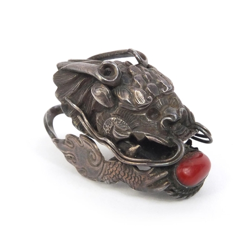 529 - Chinese unmarked silver dragon head ring set with coral, 4.5cm long, approximate weight 10.2g