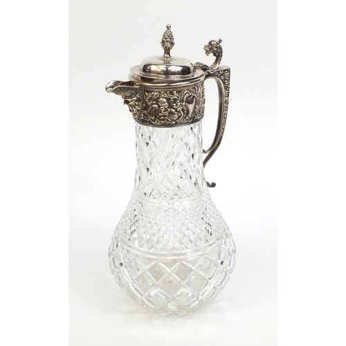 763 - Cut glass and silver claret jug, embossed with putty, griffin spout and acorn finial, hallmarked Lon... 