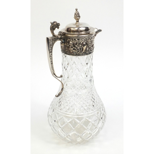 763 - Cut glass and silver claret jug, embossed with putty, griffin spout and acorn finial, hallmarked Lon... 