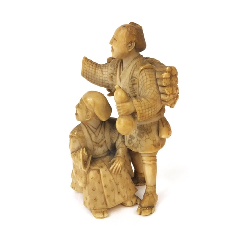 504 - Japanese carved ivory okimono of a wood carrier holding a double gourd sake bottle beside a seated e... 