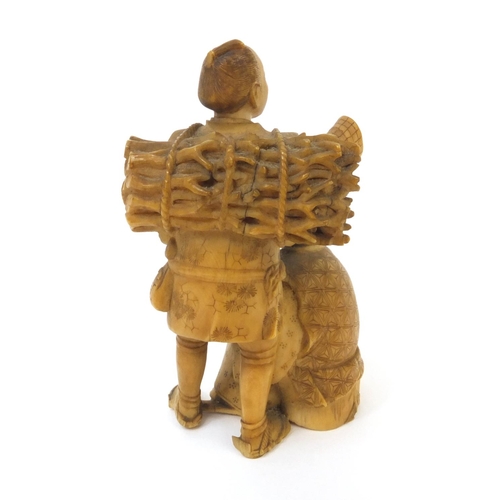 504 - Japanese carved ivory okimono of a wood carrier holding a double gourd sake bottle beside a seated e... 