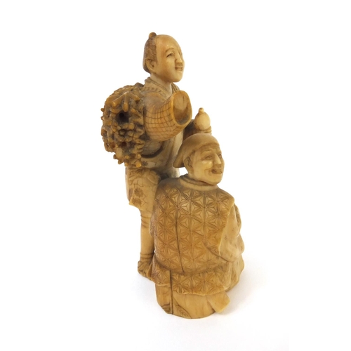 504 - Japanese carved ivory okimono of a wood carrier holding a double gourd sake bottle beside a seated e... 