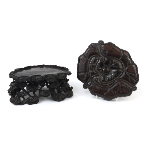 546 - Two Chinese hardwood stands one carved with clouds the other as a lotus flower, the largest 11cm hig... 