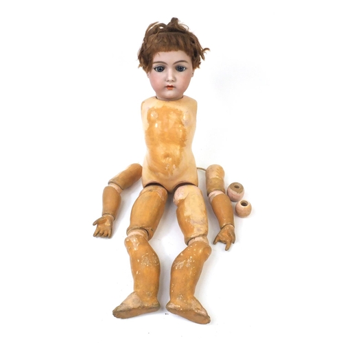 440 - Bisque headed doll with open close eyes and composite body and limbs, the head 15cm high