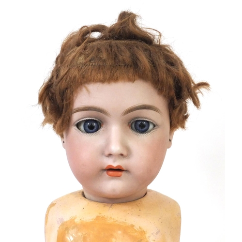 440 - Bisque headed doll with open close eyes and composite body and limbs, the head 15cm high