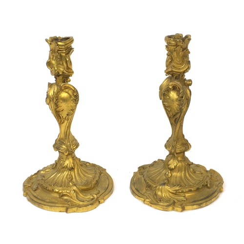 33 - Pair of 19th century Rococo style ormolu candlesticks with scroll and acanthus decoration, each 24cm... 