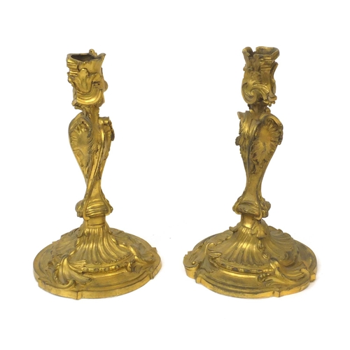 33 - Pair of 19th century Rococo style ormolu candlesticks with scroll and acanthus decoration, each 24cm... 