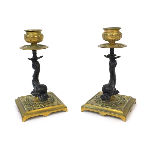 36 - Pair of gilt brass candlesticks with dolphin supports, each 14.5cm high