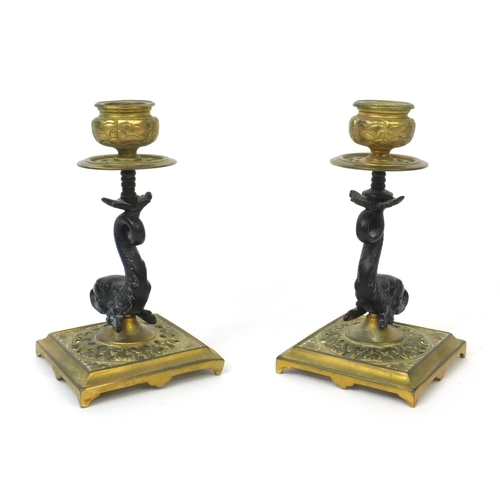 36 - Pair of gilt brass candlesticks with dolphin supports, each 14.5cm high