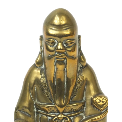 568 - Chinese brass Buddha riding a crane with incised decoration, 20cm high