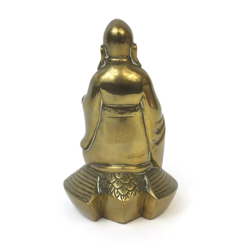 568 - Chinese brass Buddha riding a crane with incised decoration, 20cm high