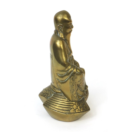 568 - Chinese brass Buddha riding a crane with incised decoration, 20cm high