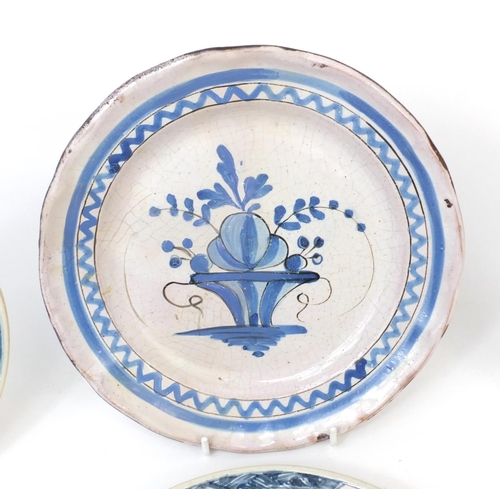 599 - Four antique delft plates hand painted with flowers, each approximately 24cm in diameter
