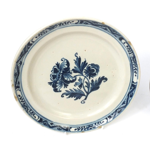 599 - Four antique delft plates hand painted with flowers, each approximately 24cm in diameter