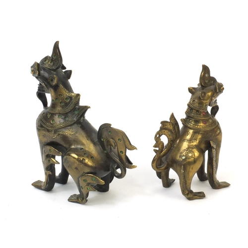 570 - Two Oriental brass figures of mythical beasts both inset with colourful stones, the largest 19cm hig... 