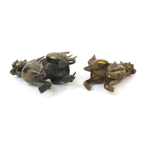 570 - Two Oriental brass figures of mythical beasts both inset with colourful stones, the largest 19cm hig... 