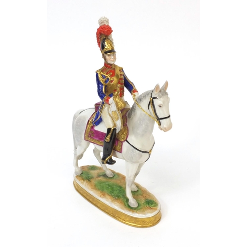 395 - Military interest hand painted porcelain figure of a trumpeter on horseback, factory marks to the ba... 