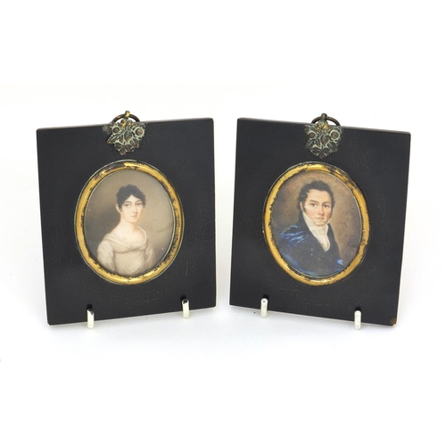 16 - Pair of 19th century oval portrait miniatures, one of a gentleman wearing a blue coat, the other of ... 