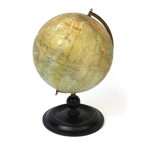47 - Philips 9inch terrestrial globe for the London Geographical Institute, with brass arch and turned wo... 