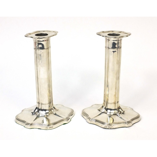 761 - Pair of silver column candlesticks with shaped bases, indistinct makers mark, Sheffield 1906, 19cm h... 