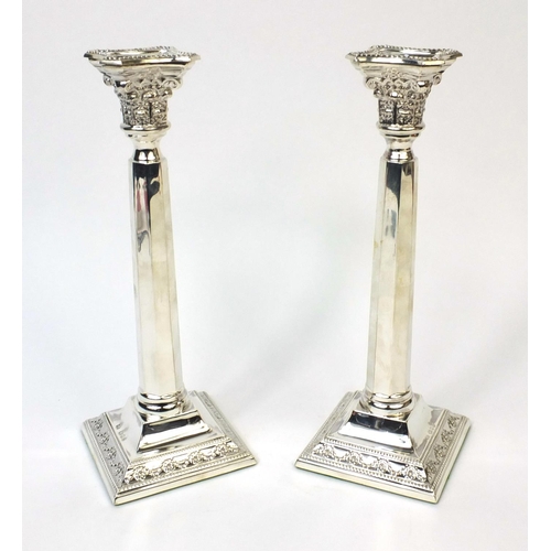 744 - Pair of silver square based column candlesticks embossed with swags, R.S London 1938, 27cm high, app... 