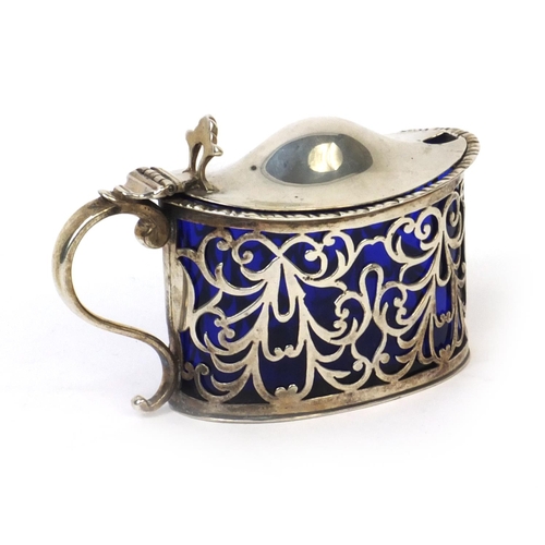 775 - Silver mustard with hinged lid and blue glass liner, hallmarked London 1899, 7cm high, approximate w... 