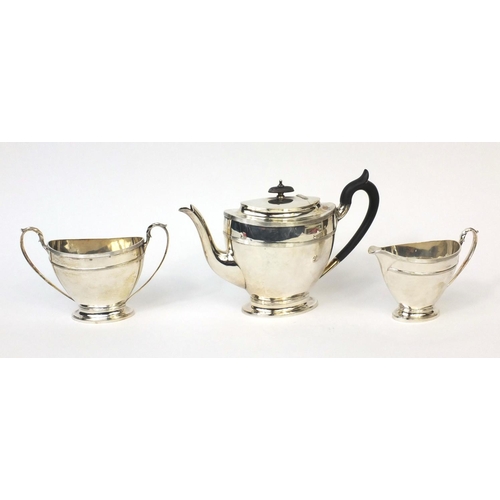 741 - Silver three piece tea service, the teapot with ebonised handle and knop, J.D & S Sheffield 1908, th... 