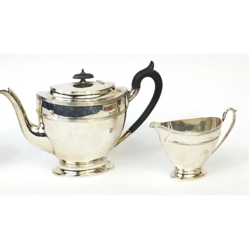 741 - Silver three piece tea service, the teapot with ebonised handle and knop, J.D & S Sheffield 1908, th... 