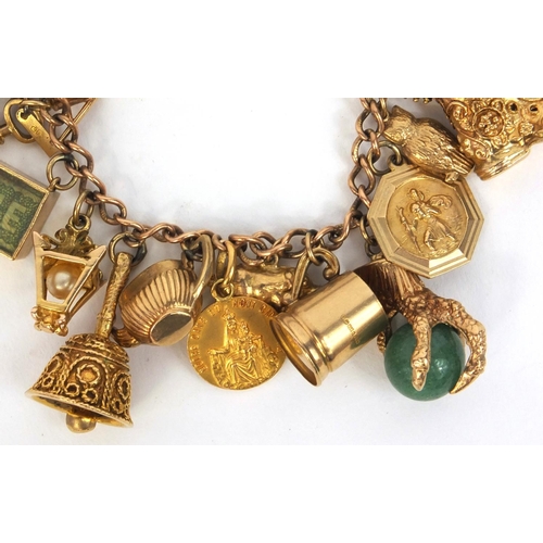 799 - Heavy 9ct gold charm bracelet with large selection of 9ct gold charms including animals, emergency £... 