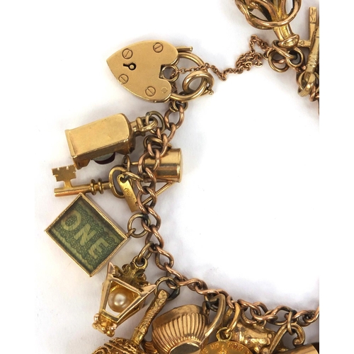 799 - Heavy 9ct gold charm bracelet with large selection of 9ct gold charms including animals, emergency £... 