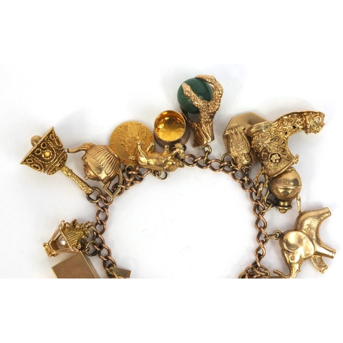 799 - Heavy 9ct gold charm bracelet with large selection of 9ct gold charms including animals, emergency £... 