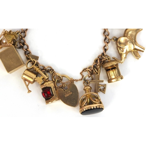 799 - Heavy 9ct gold charm bracelet with large selection of 9ct gold charms including animals, emergency £... 