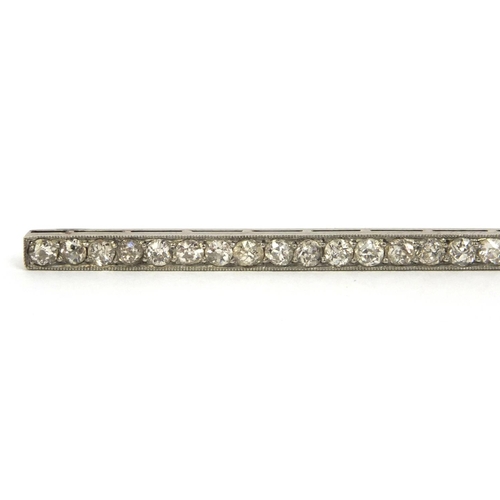 810 - Art Deco unmarked diamond bar brooch set with twenty nine diamonds, 8cm long, approximate weight 6.0... 