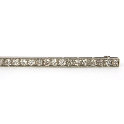 810 - Art Deco unmarked diamond bar brooch set with twenty nine diamonds, 8cm long, approximate weight 6.0... 