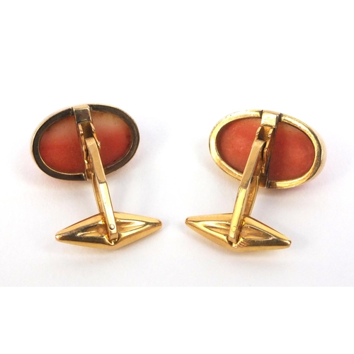 805 - Pair of 18ct gold greyhound carved coral cufflinks, approximate weight 9.8g