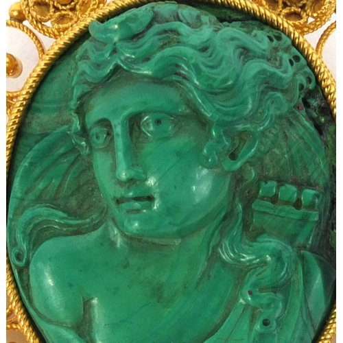 846 - Dianna the huntress carved malachite brooch, with unmarked gold mount, 4cm high, approximate weight ... 