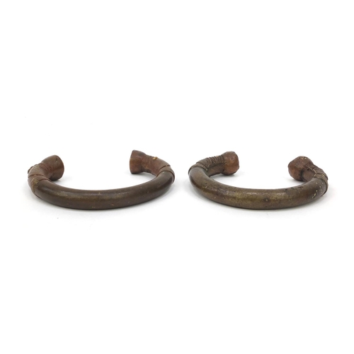 332 - Two African bronze bangles, each 10cm wide