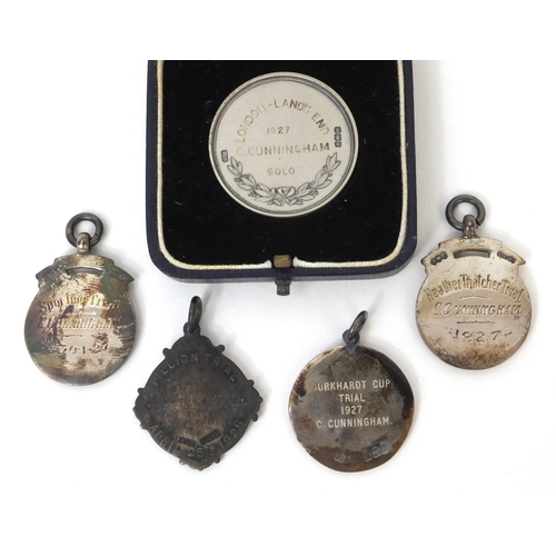 180 - Group of four silver and enamel motor cycle jewels together with a motorcycling club silver award, e... 
