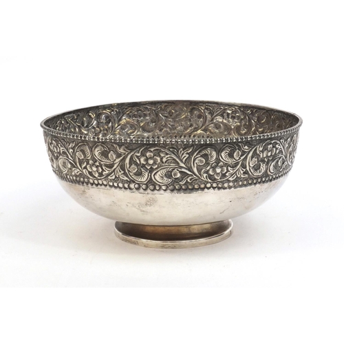 756 - Circular silver pedestal bowl embossed with flowers, stamped silver to the base, 20.5cm in diameter,... 