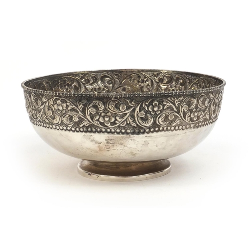756 - Circular silver pedestal bowl embossed with flowers, stamped silver to the base, 20.5cm in diameter,... 