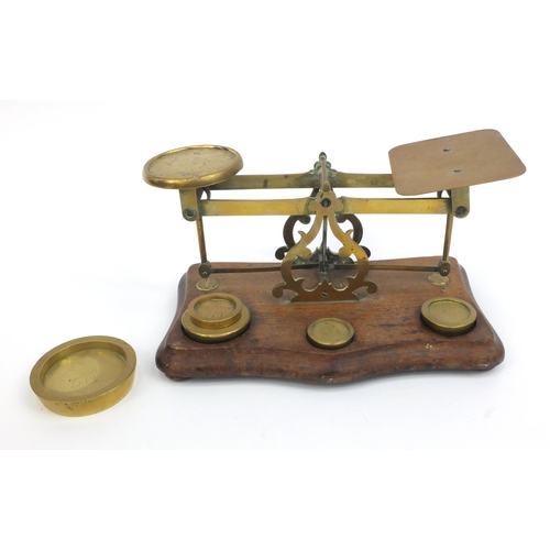 2220 - Pair of brass and mahogany postage scales with weights, 12cm high