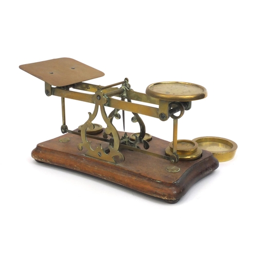 2220 - Pair of brass and mahogany postage scales with weights, 12cm high