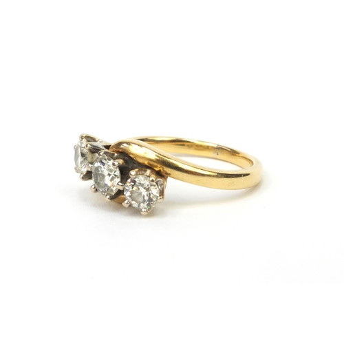 825 - 18ct gold modern round brilliant cut diamond three stone crossover ring, size L, approximate weight ... 