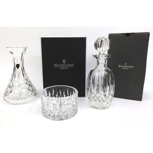 2307 - Group of Waterford Crystal comprising boxed decanter, boxed vase and a wine coaster, the tallest 30c... 