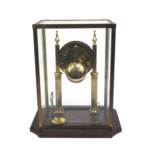 2331 - Brass mantle clock with enamelled dial striking on a bell, house under a brass and glass case, 31cm ... 