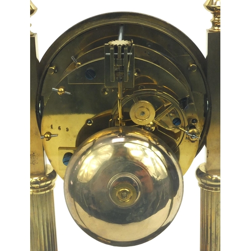 2331 - Brass mantle clock with enamelled dial striking on a bell, house under a brass and glass case, 31cm ... 